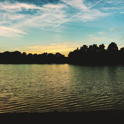 Scenic view of lake against sky at sunset