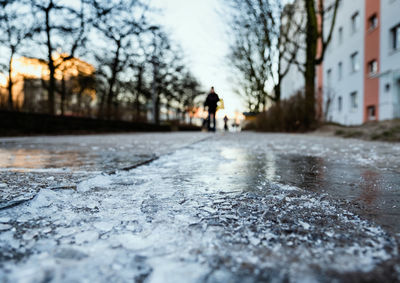 Rear view of man walking on road