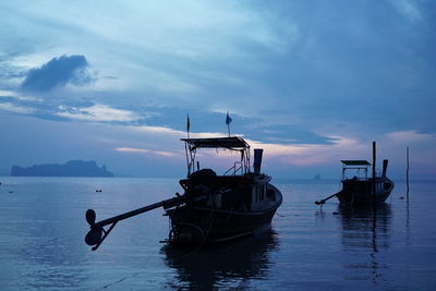 Boat moored on sea against sky