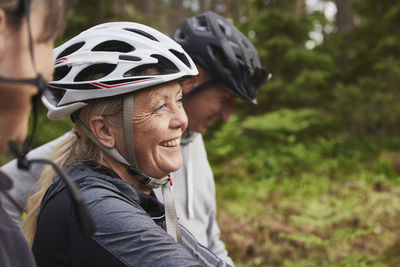 People in bicycle helmets in forest