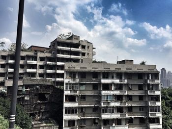 Low angle view of building against cloudy sky