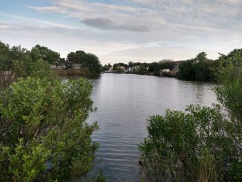 Scenic view of lake against cloudy sky