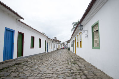 Footpath amidst buildings in city