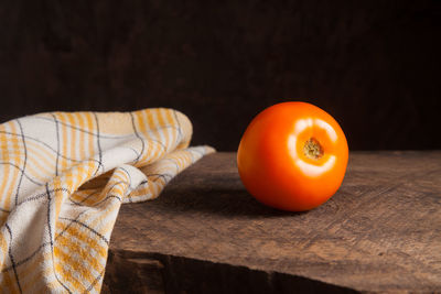 Cropped hand of man with tomatoes on table