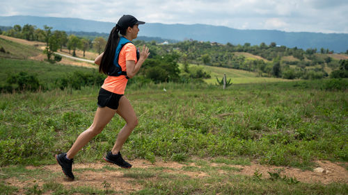 Full length of woman running on field