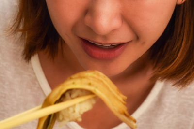 Close-up portrait of woman eating food