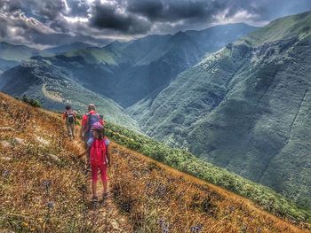 People on mountain road against sky