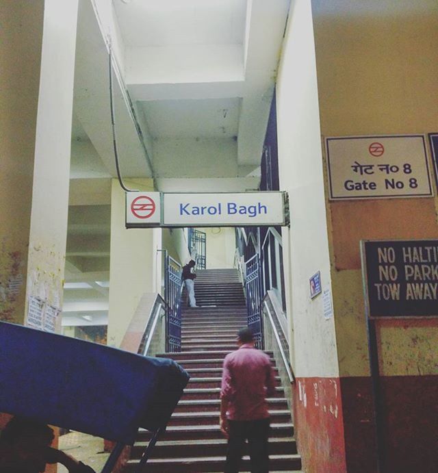 text, western script, communication, men, lifestyles, indoors, non-western script, information sign, transportation, public transportation, sign, travel, leisure activity, person, rear view, railroad station, standing, subway station