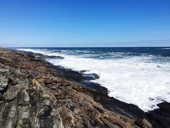 Scenic view of sea against clear blue sky