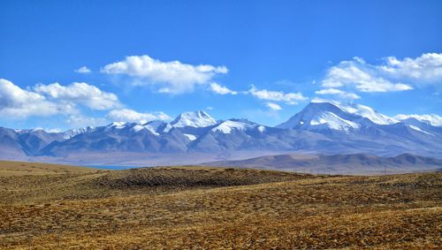 Scenic view of mountains against cloudy sky