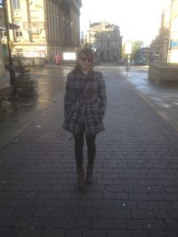 Woman walking on wet street in rainy season