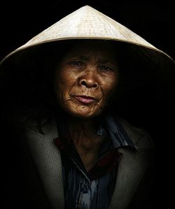 Close-up of young woman over black background