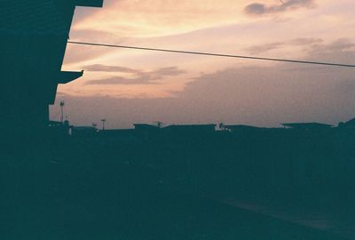 Aerial view of cityscape against sky during sunset