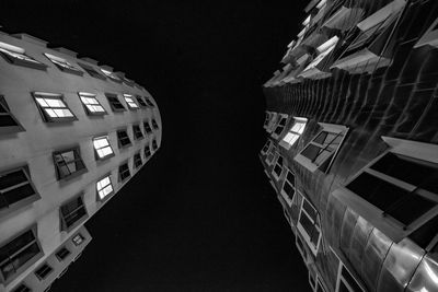 Low angle view of buildings in city at night