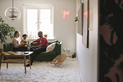 Parents playing with daughter at home