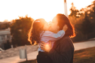 Side view of a beautiful young woman lying at sunset