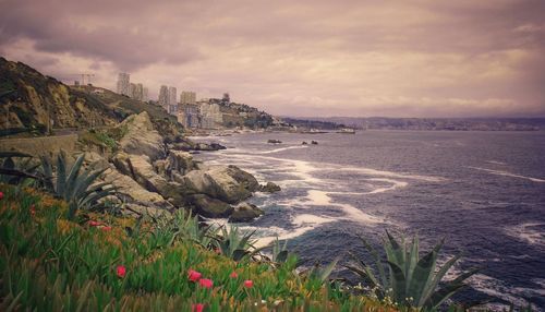 Scenic view of sea and buildings against sky