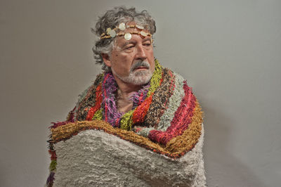 Portrait of man looking away against white background