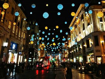 People walking on street in city at night