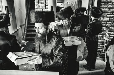 Men standing on books