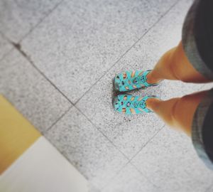 Low section of person standing on multi colored pattern