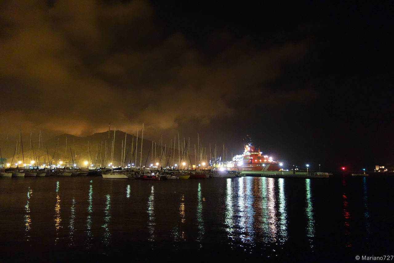 illuminated, night, water, waterfront, reflection, sky, sea, building exterior, architecture, river, built structure, city, nautical vessel, harbor, lake, outdoors, no people, lighting equipment, tranquility, scenics