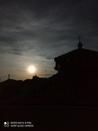 Low angle view of silhouette building against sky during sunset