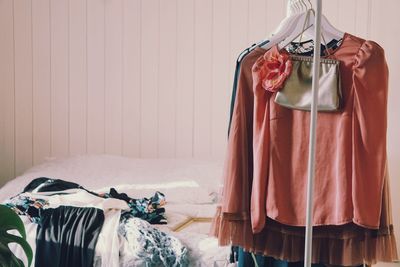 Clothes hanging on rack against wall at home