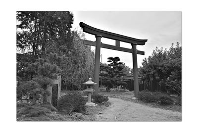 Built structure by trees against sky