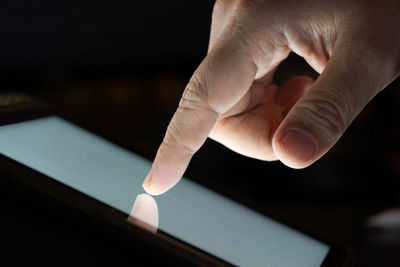 Close-up of hand touching smart phone