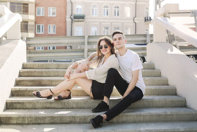 Full length of woman sitting on staircase