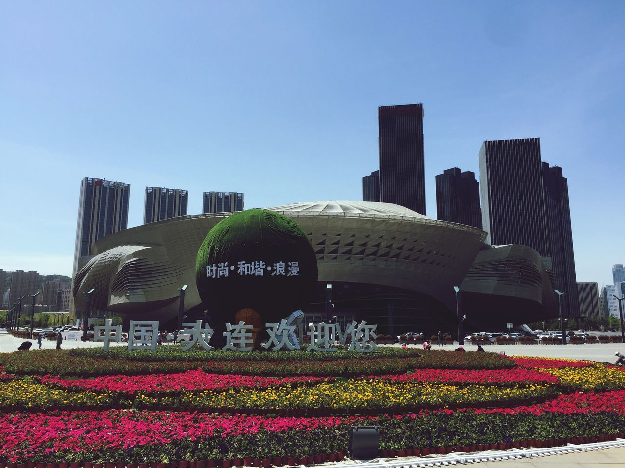 flower, architecture, built structure, clear sky, building exterior, freshness, fragility, growth, blooming, plant, city, sky, flowerbed, blue, formal garden, day, petal, outdoors, travel destinations, in bloom