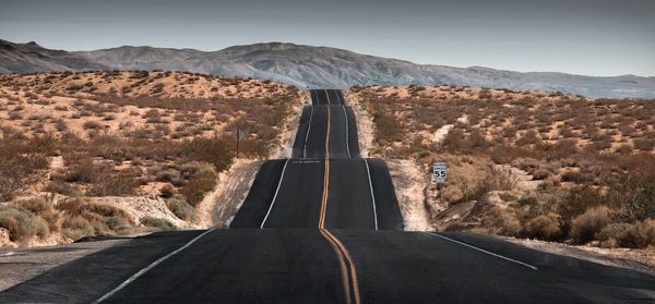 Road in desert against clear sky