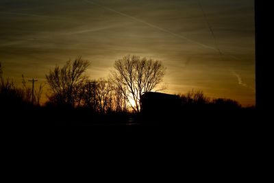 Silhouette trees against sky during sunset