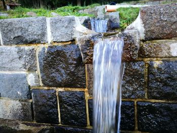 Close-up of water fountain against white wall