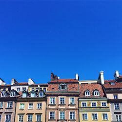 Low angle view of buildings against clear blue sky