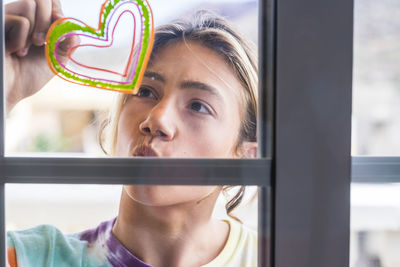 Close-up girl seen through glass window