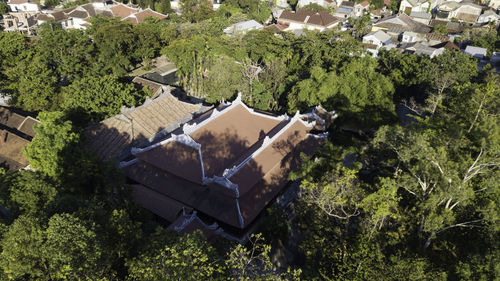 High angle view of houses and trees on field