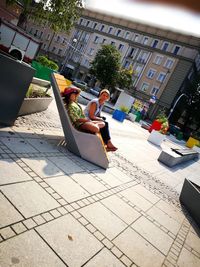 Woman sitting on floor in city