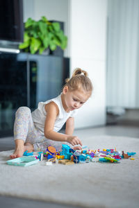 Side view of boy playing with toys on table