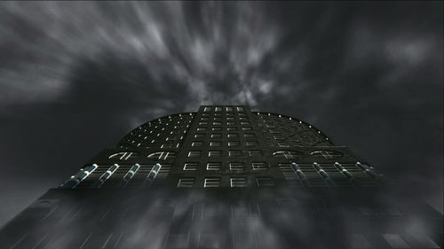 Low angle view of modern building against cloudy sky