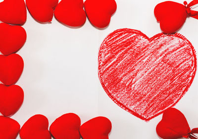 Close-up of red heart shape over white background