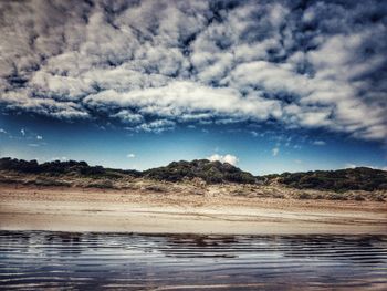 Scenic view of landscape against cloudy sky