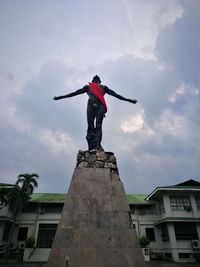 Low angle view of statue against cloudy sky
