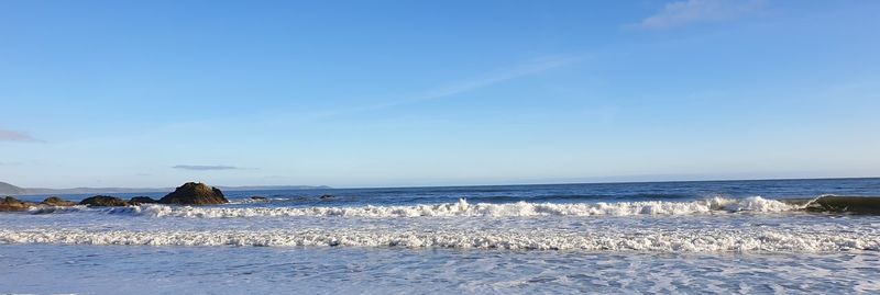 Scenic view of sea against blue sky