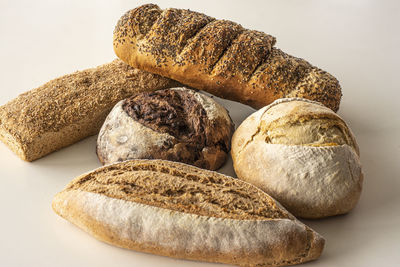 Close-up of bread on table against white background