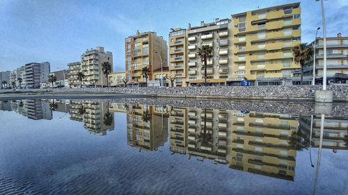 Reflection of buildings in puddle