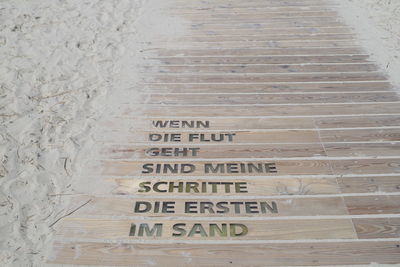 High angle view of text on footpath