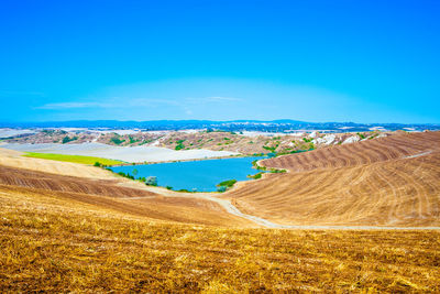 Panoramic view of landscape against blue sky