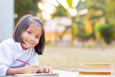 Portrait of a smiling girl sitting on table